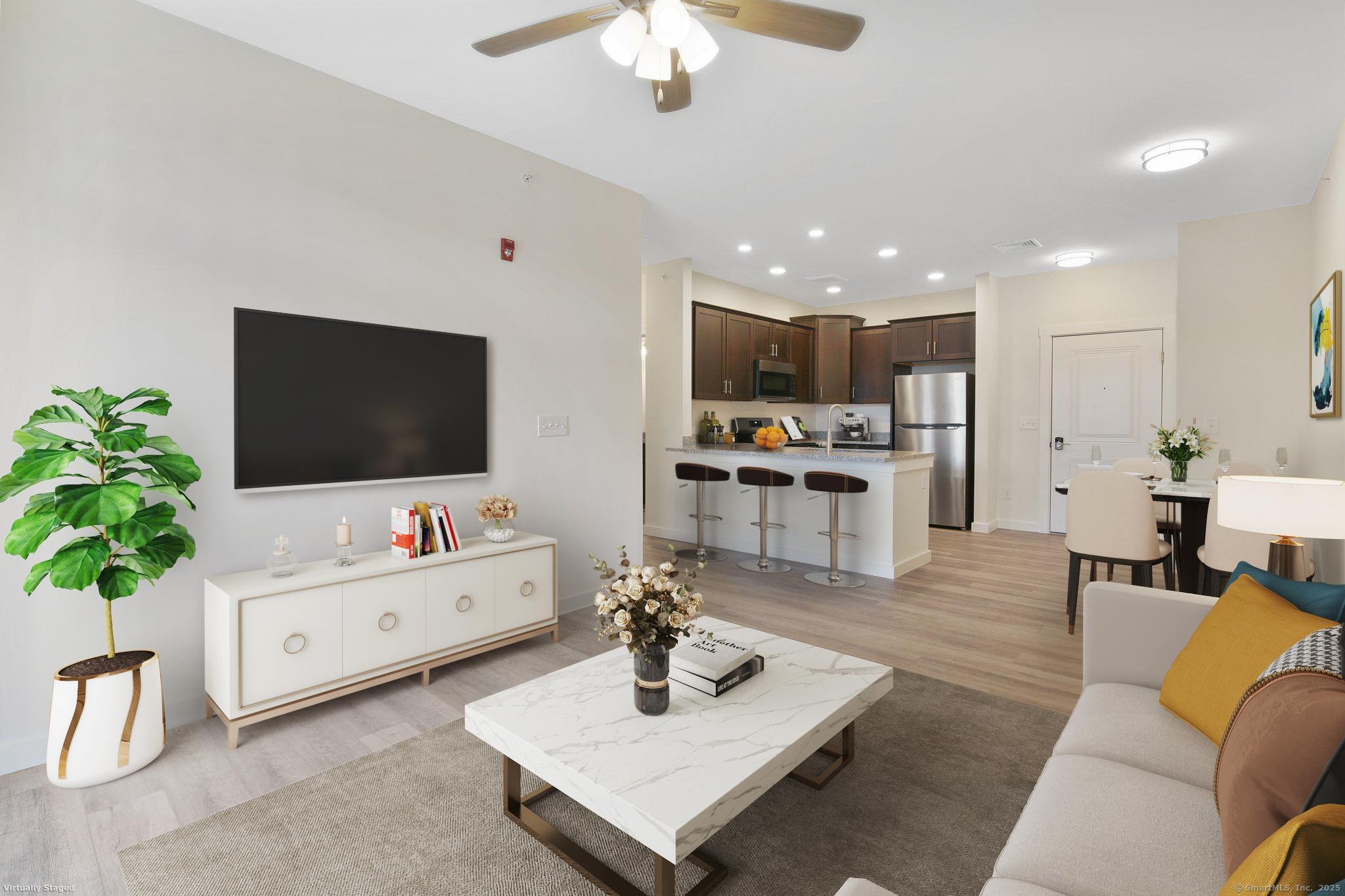280 Salmon Brook Street, Unit 4311 Granby, CT 06035 - Photo 7 of 26 a living room with furniture and a flat screen tv