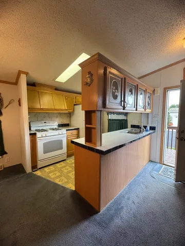 a kitchen with stainless steel appliances granite countertop a stove and a sink