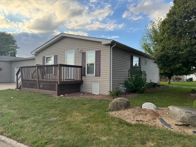 a view of a house with a yard and deck