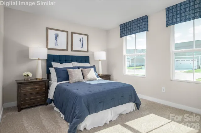 a bedroom with a bed windows and a lamp