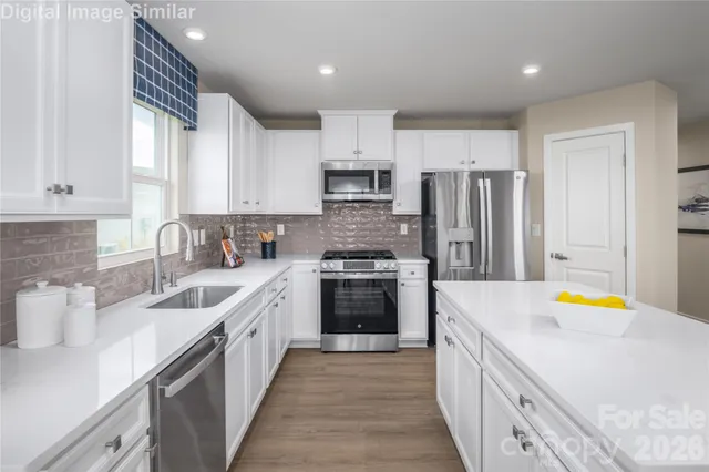 a kitchen with stainless steel appliances a stove sink and cabinets