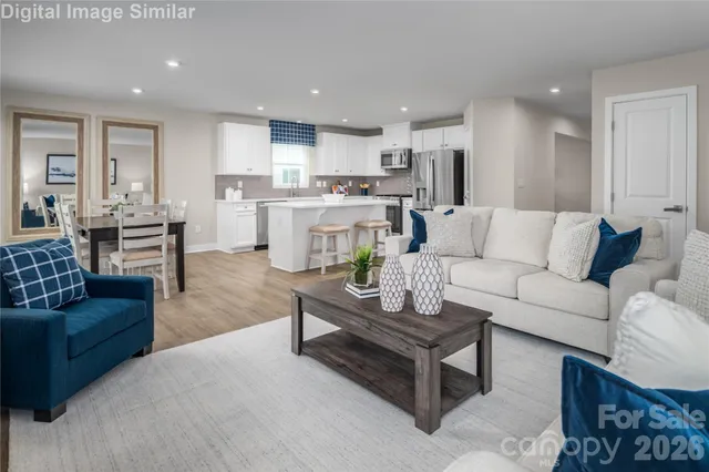 a living room with furniture and kitchen view
