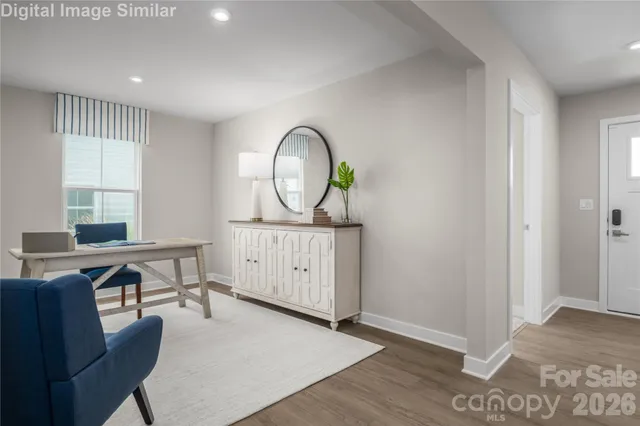 a view of a workspace with furniture window and wooden floor