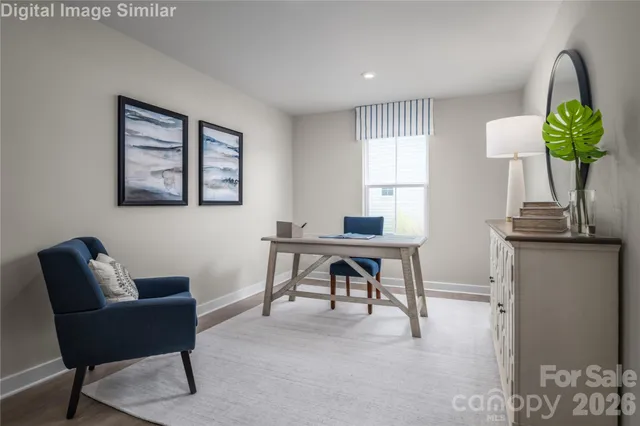 a work room with furniture and a potted plant