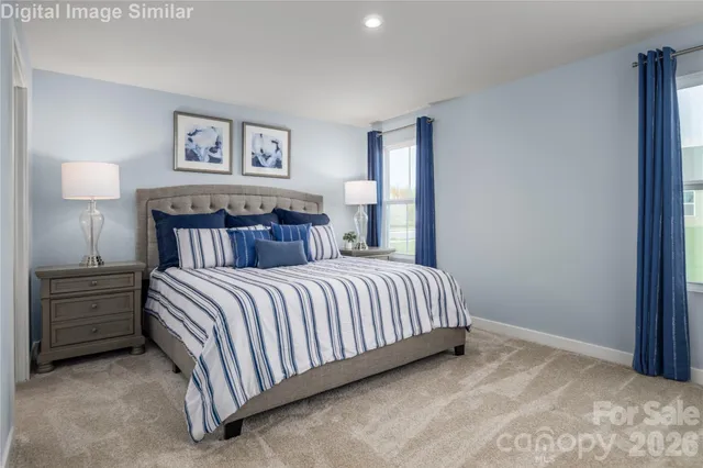 a bedroom with a bed and lamp