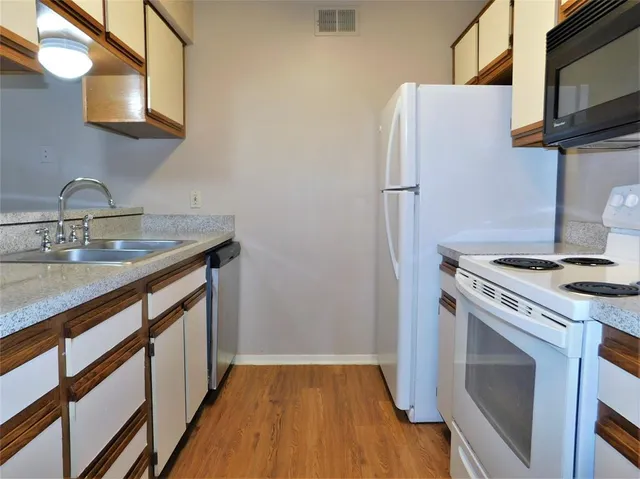 a kitchen with a stove sink and refrigerator