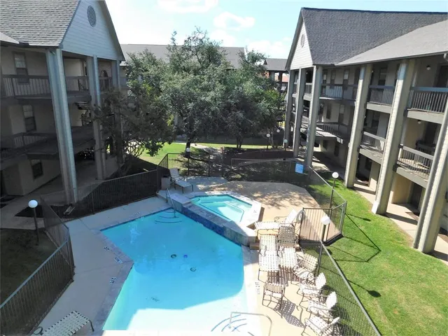 a view of yard from deck with patio
