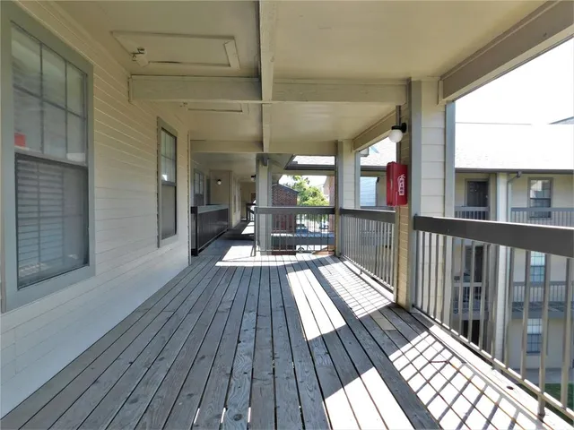 a view of a balcony with wooden floor