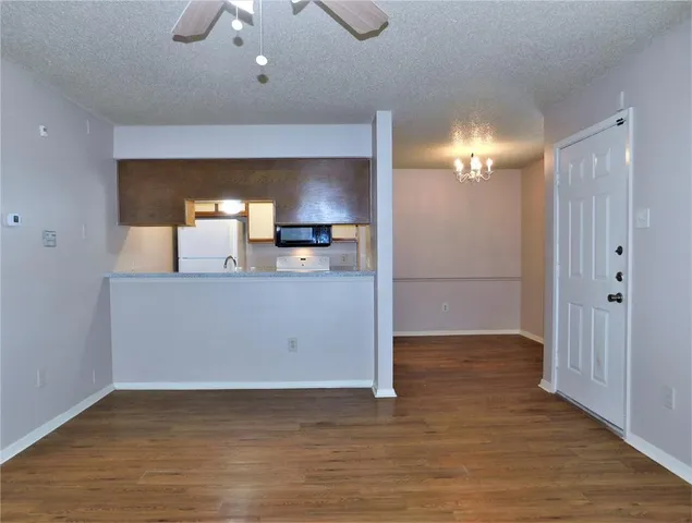 a view of a kitchen with a sink cabinets and wooden floor