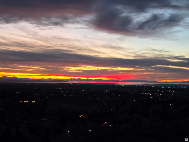 5057 South Ridgedale Drive Ogden, UT 84403 - Photo 67 of 69 Expansive evening horizon featuring a vibrant sunset sky, distant mountain range, and scattered city lights