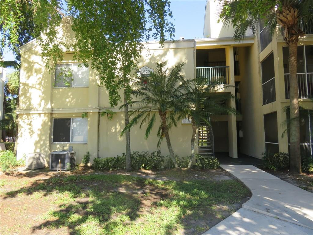 5672 Rock Island Road, Unit 239 Tamarac, FL 33319 - Photo 1 of 16 a front view of a house with garden