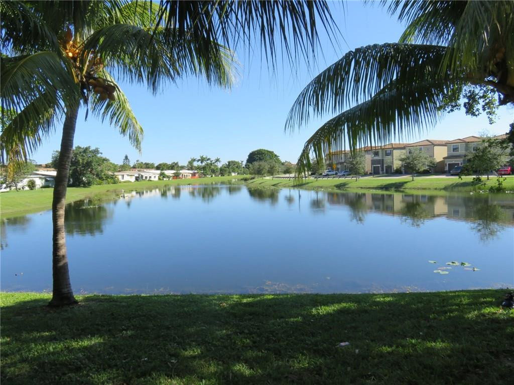 5672 Rock Island Road, Unit 239 Tamarac, FL 33319 - Photo 15 of 16 a view of a lake with palm trees