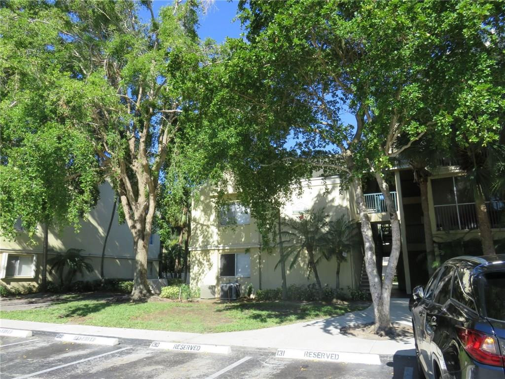 5672 Rock Island Road, Unit 239 Tamarac, FL 33319 - Photo 16 of 16 a front view of a house with garden