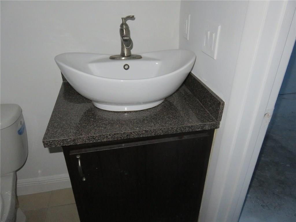 5672 Rock Island Road, Unit 239 Tamarac, FL 33319 - Photo 3 of 16 a close view of a sink a faucet and washer