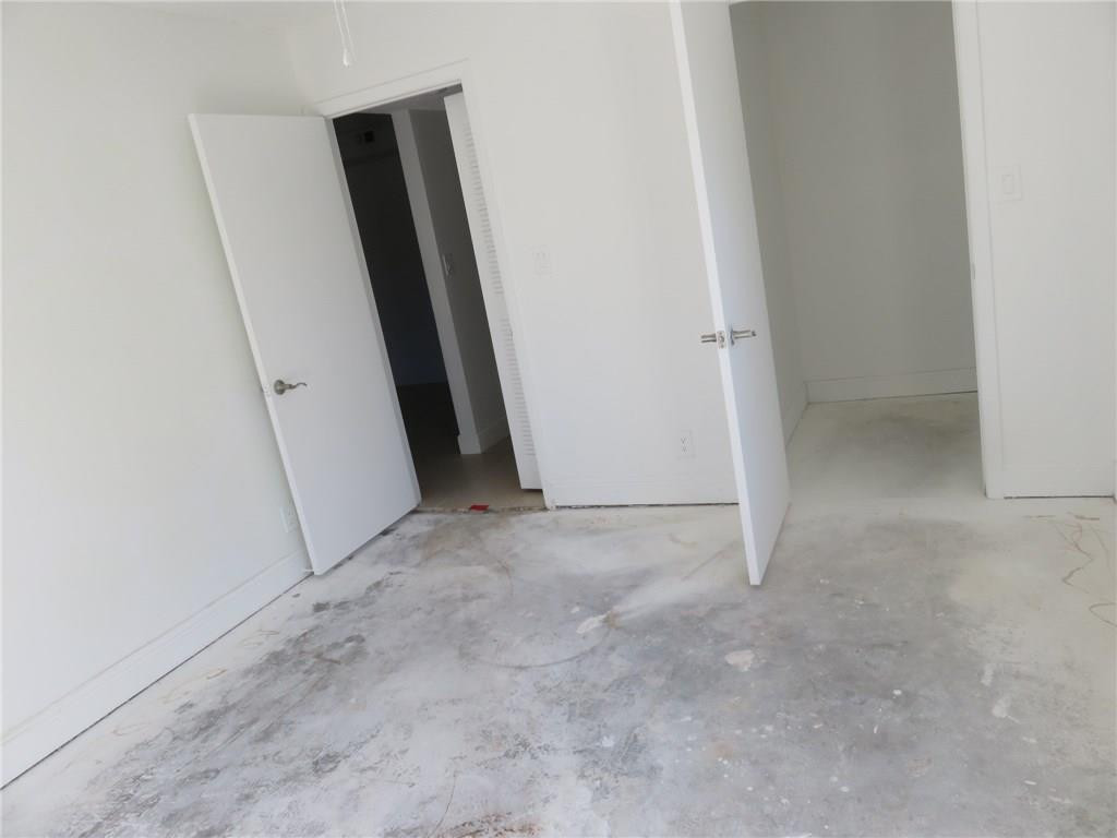 5672 Rock Island Road, Unit 239 Tamarac, FL 33319 - Photo 8 of 16 an empty room with windows
