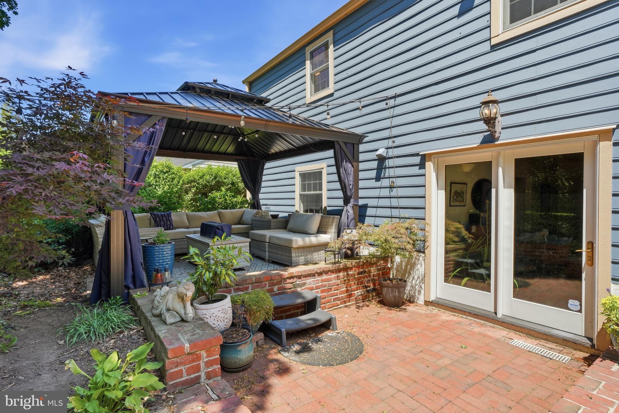 621 River Road Yardley, PA 19067 - Photo 54 of 75 a view of a patio with table and chairs and potted plants
