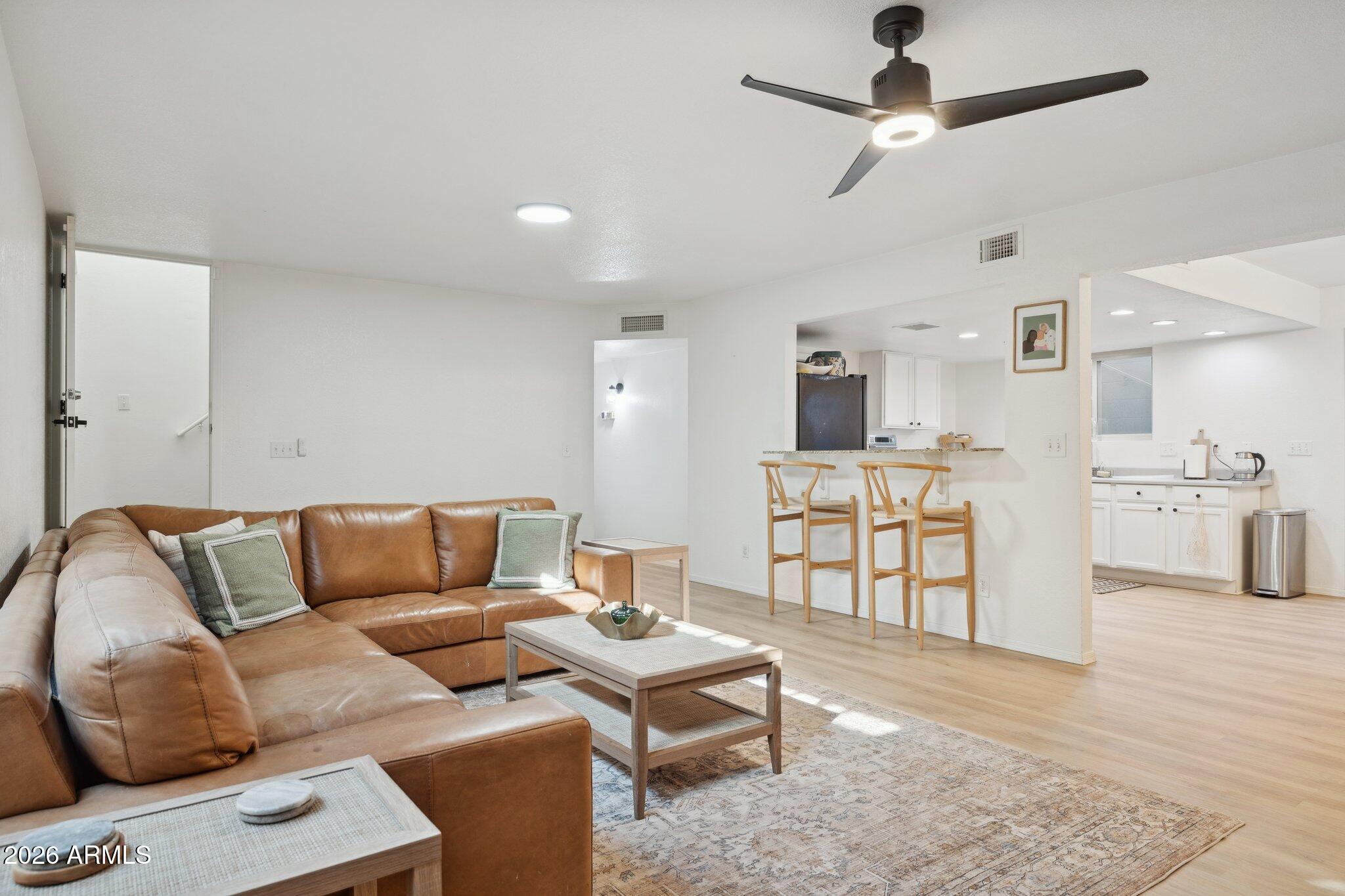 16226 East Fairview Street Gilbert, AZ 85295 - Photo 24 of 59 a living room with furniture kitchen view and a wooden floor