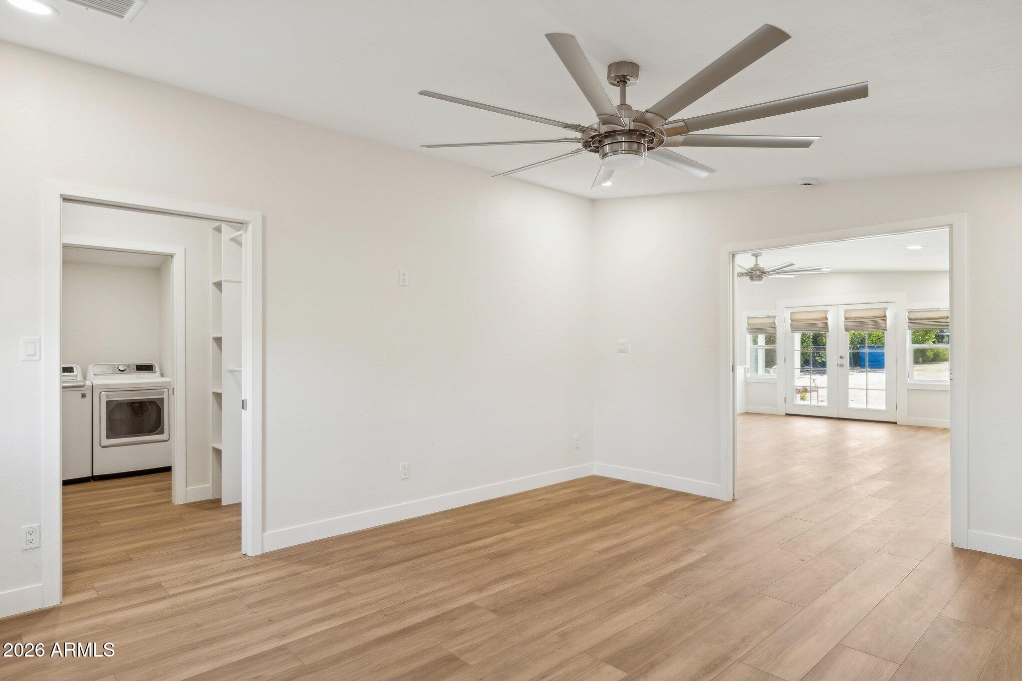 16226 East Fairview Street Gilbert, AZ 85295 - Photo 44 of 59 a view of a livingroom with a ceiling fan wooden floor and window