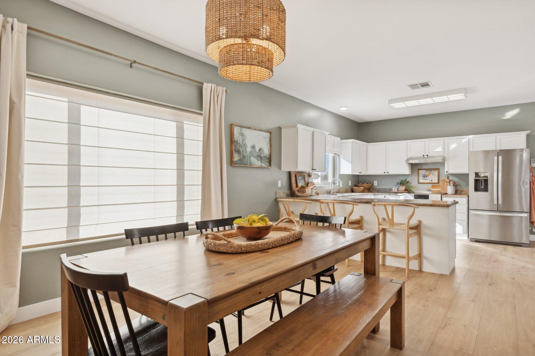 16226 East Fairview Street Gilbert, AZ 85295 - Photo 5 of 59 a kitchen with a dining table chairs and microwave