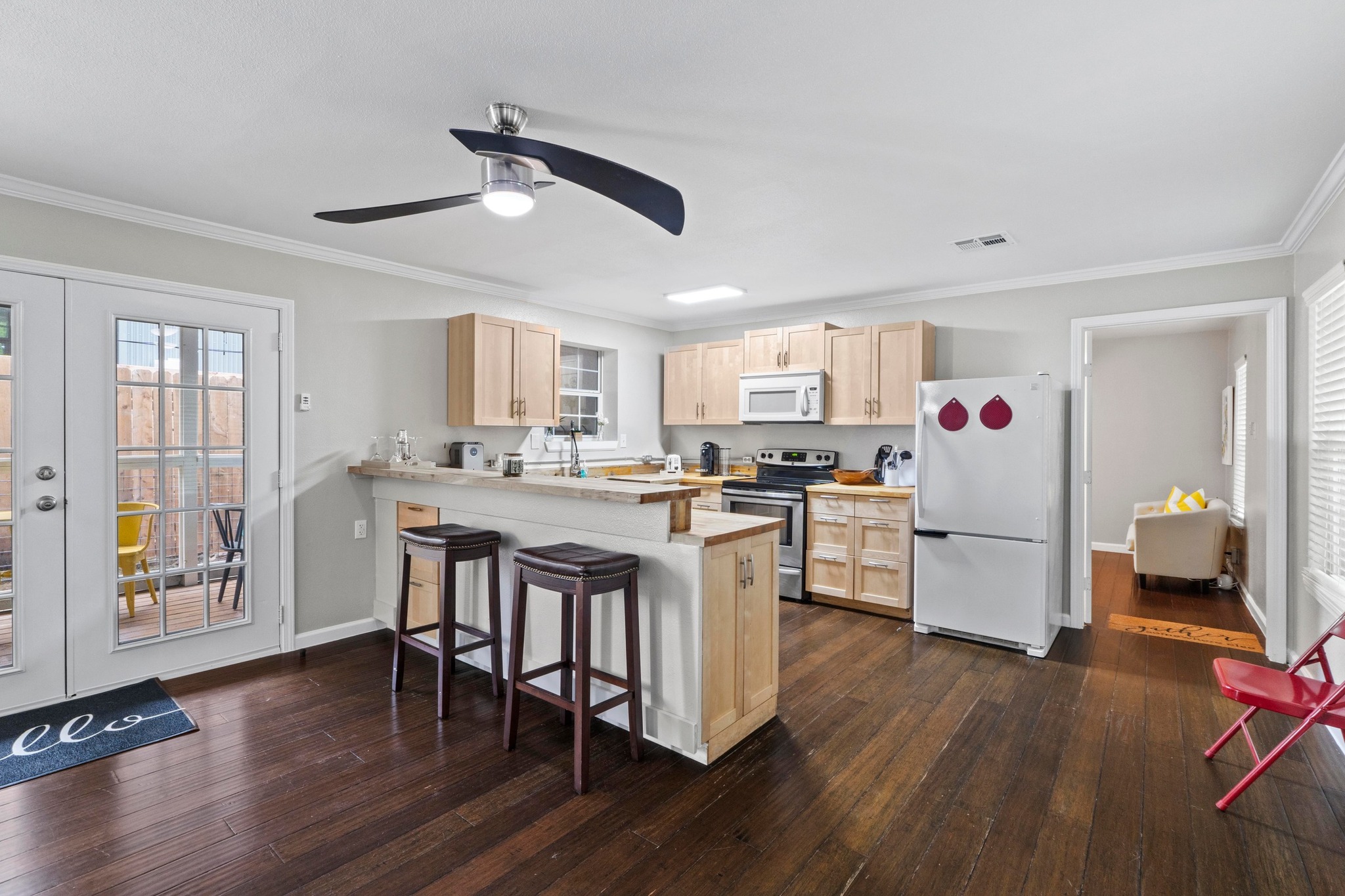 4512 Speedway, Unit A Austin, TX 78751 - Photo 13 of 39 a kitchen with a refrigerator a white stove top oven and a dining table with wooden floor