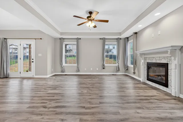 a view of an empty room with a ceiling fan