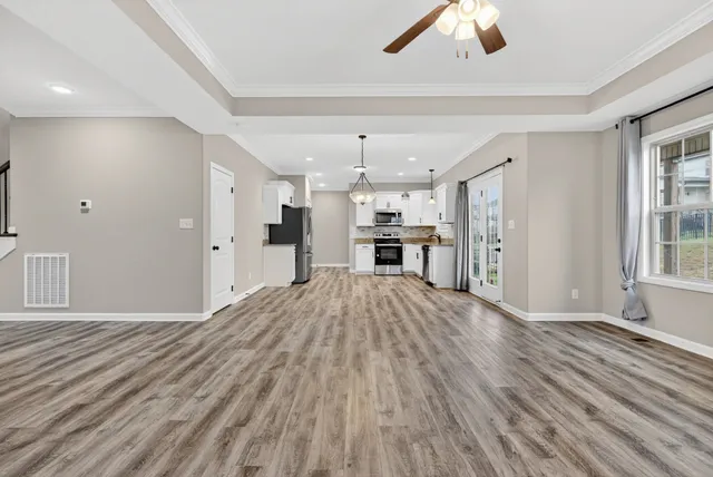 a view of kitchen with refrigerator microwave and stove top oven