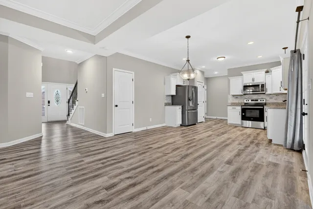 a kitchen with stainless steel appliances a refrigerator sink and stove