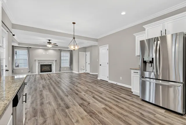 a view of a hallway to a bedroom and a ceiling fan window