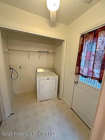 a view of an empty room with a ceiling fan