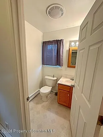 a spacious bathroom with a tub sink and mirror