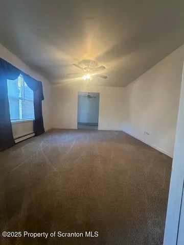 a view of a house with a yard and large tree
