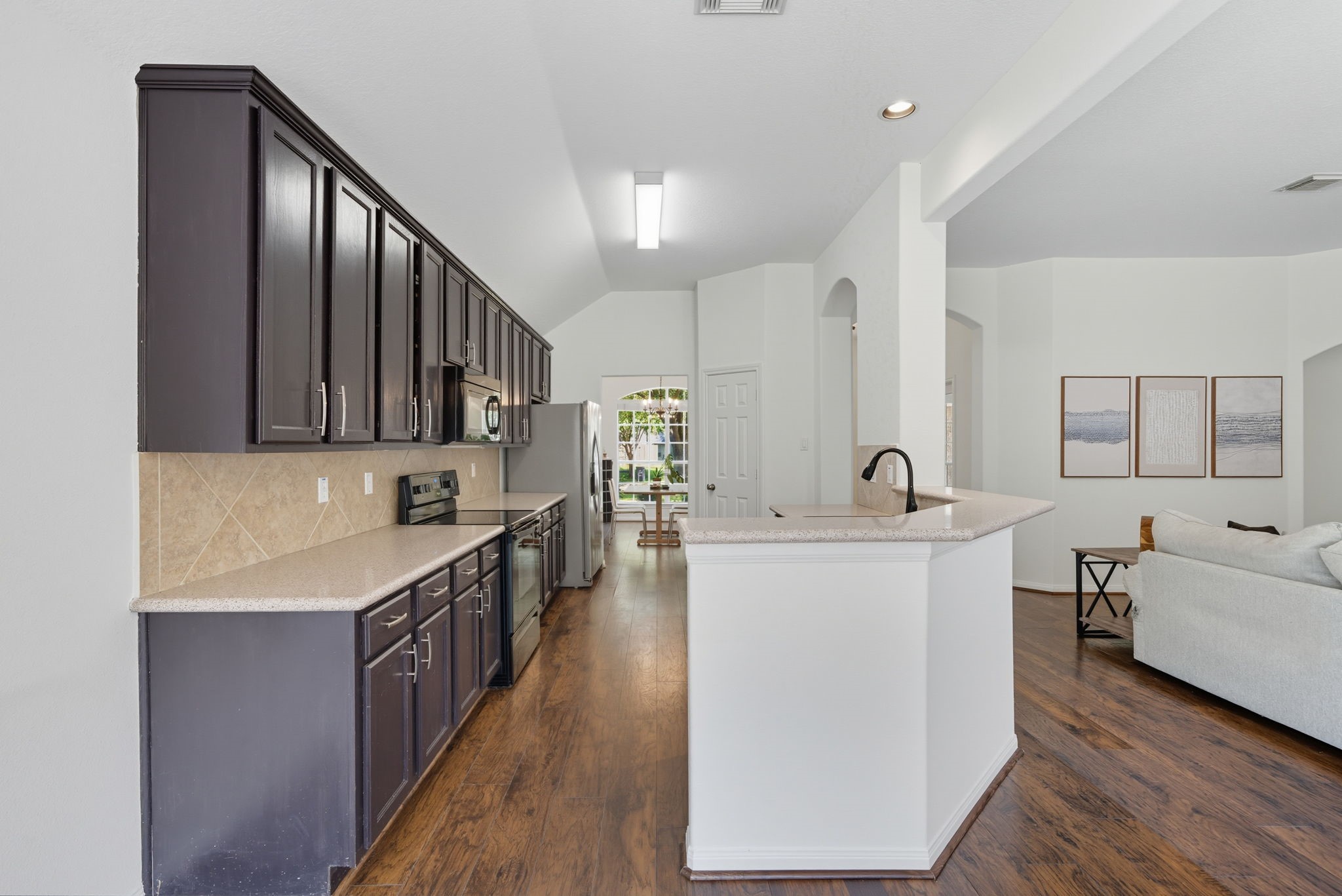 3323 Rollingwood Montgomery, TX 77356 - Photo 14 of 43 a kitchen with stainless steel appliances a sink stove top oven and cabinets