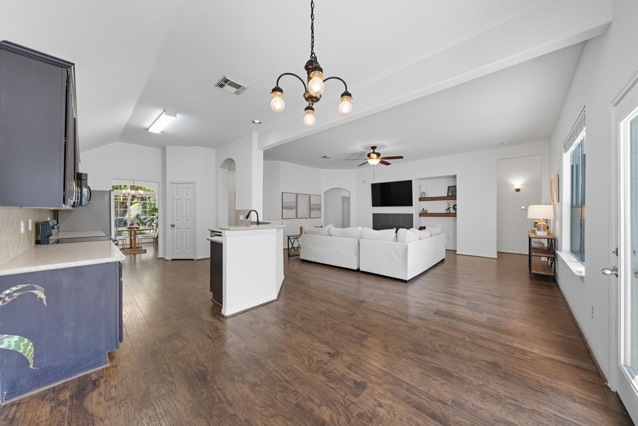 3323 Rollingwood Montgomery, TX 77356 - Photo 17 of 43 a view of a kitchen with a sink wooden floor and a window