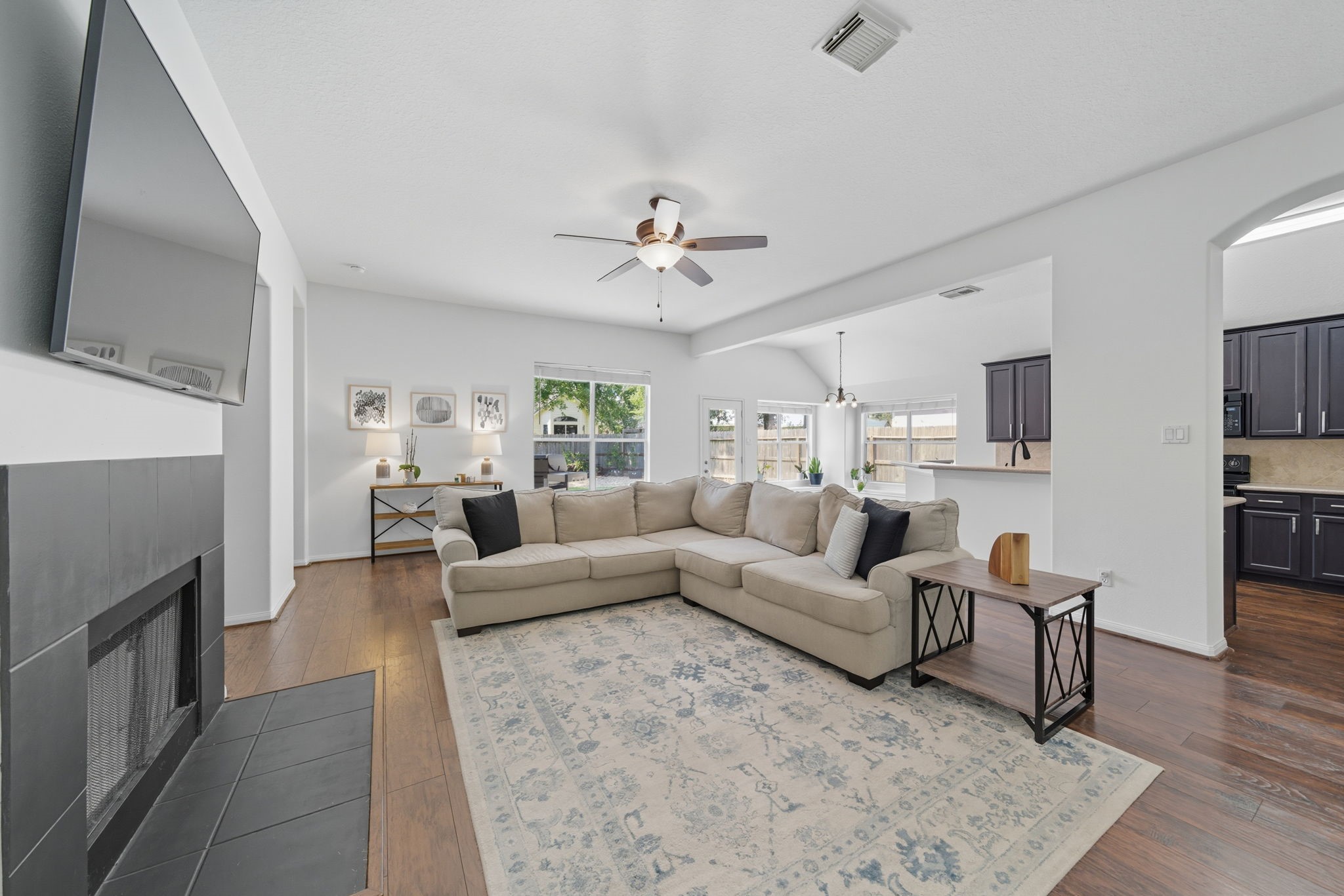 3323 Rollingwood Montgomery, TX 77356 - Photo 19 of 43 a living room with furniture a fireplace and a flat screen tv