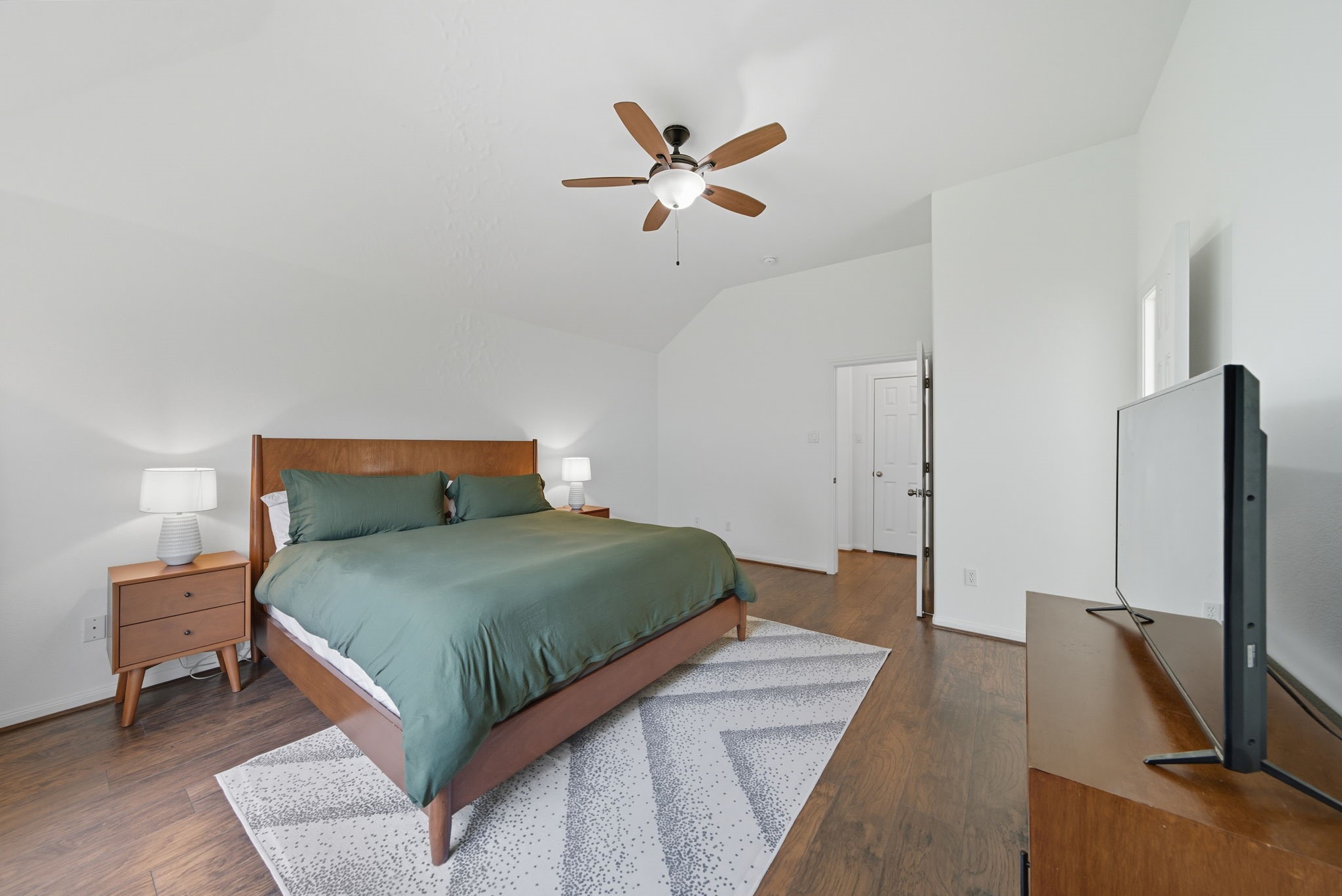 3323 Rollingwood Montgomery, TX 77356 - Photo 23 of 43 a bedroom with a bed and a flat screen tv