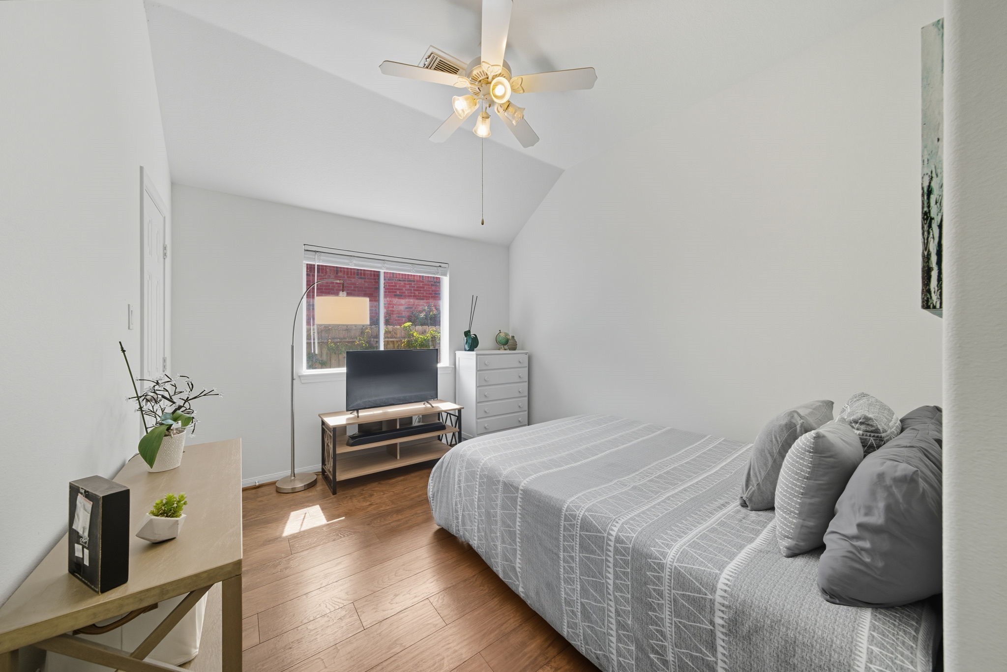 3323 Rollingwood Montgomery, TX 77356 - Photo 28 of 43 a bedroom with a bed and a chandelier