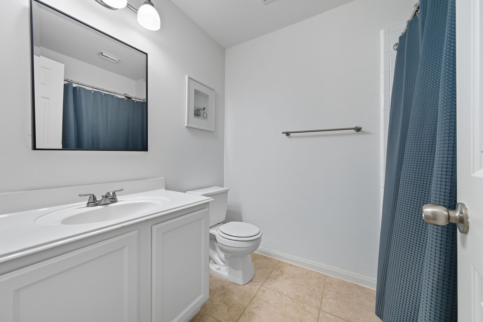 3323 Rollingwood Montgomery, TX 77356 - Photo 30 of 43 a bathroom with a toilet sink and mirror