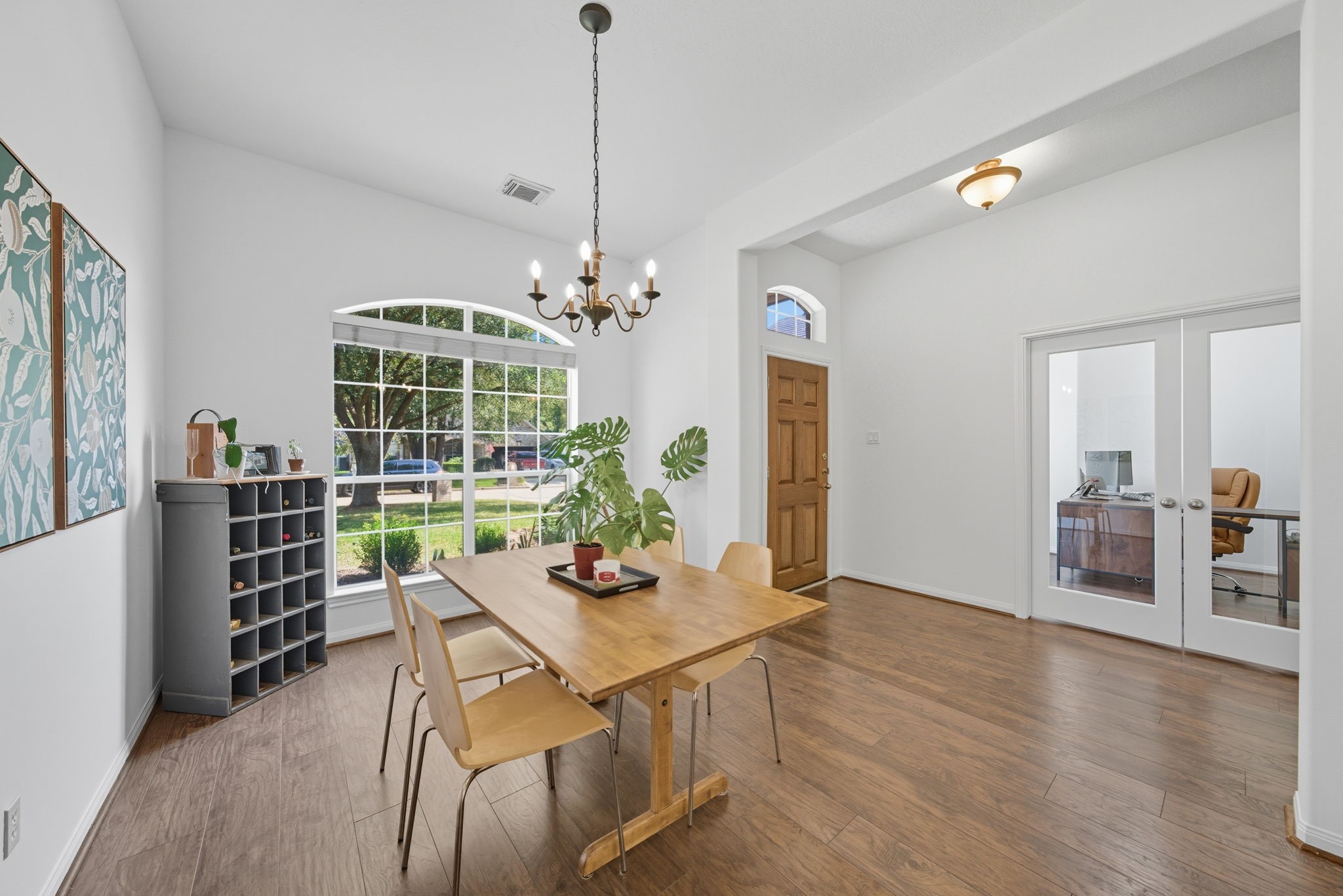 3323 Rollingwood Montgomery, TX 77356 - Photo 7 of 43 a view of a dining room and livingroom with furniture wooden floor and a chandelier