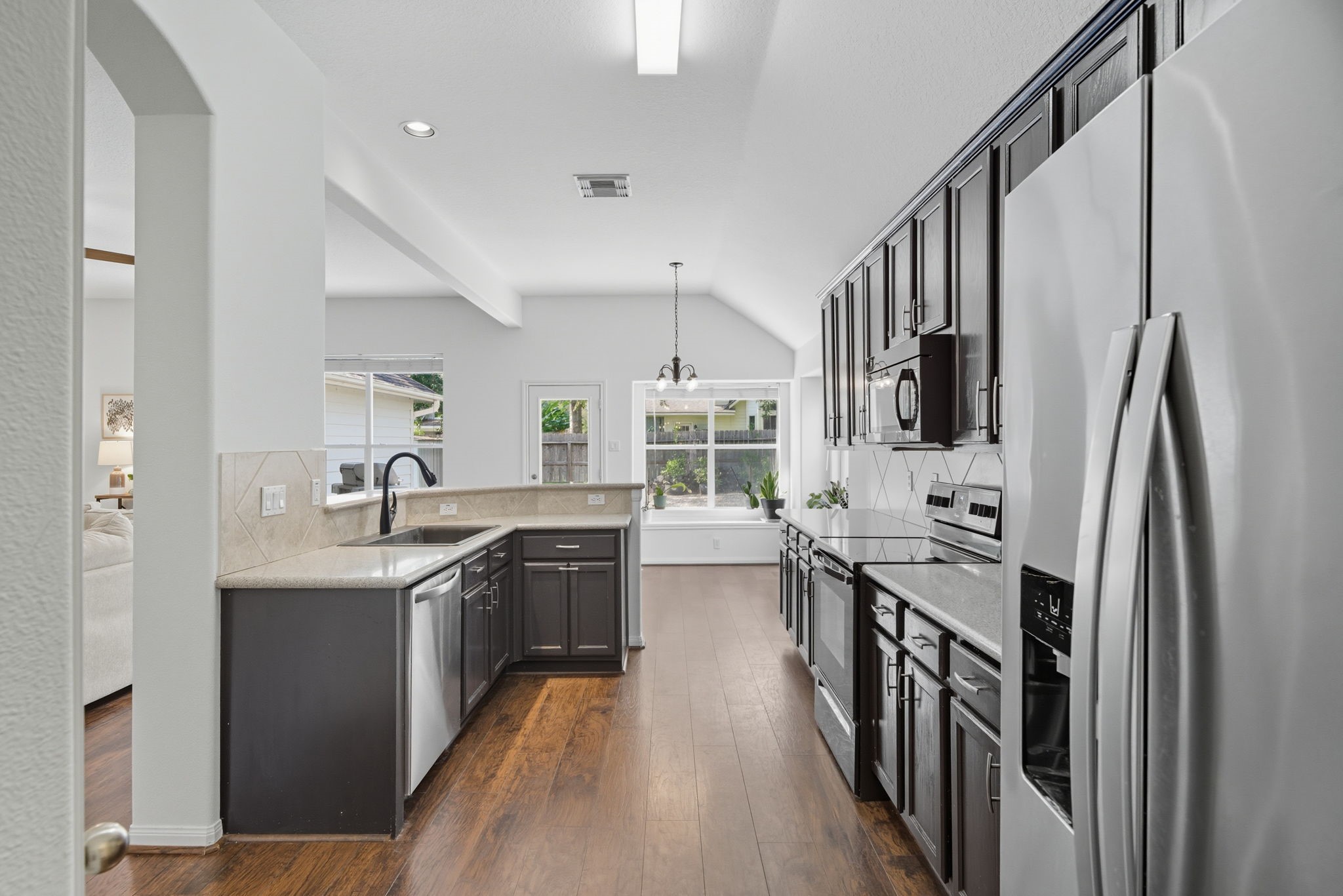 3323 Rollingwood Montgomery, TX 77356 - Photo 10 of 43 a kitchen with stainless steel appliances granite countertop a sink stove and refrigerator