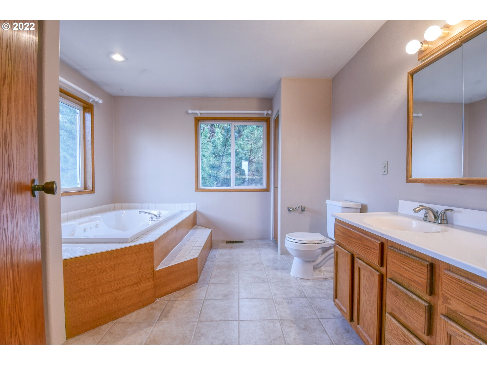 2011 Southwest Quinney Avenue Pendleton, OR 97801 - Photo 11 of 26 a bathroom with a granite countertop sink a toilet a mirror and bathtub