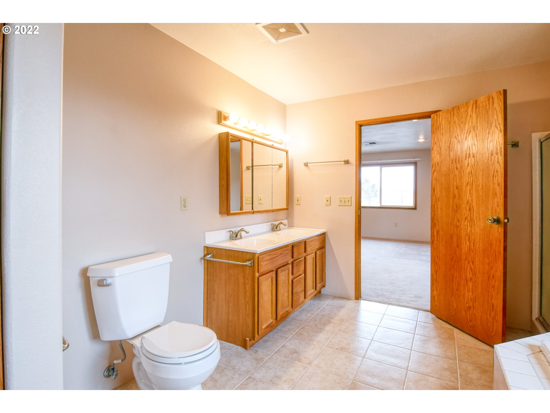 2011 Southwest Quinney Avenue Pendleton, OR 97801 - Photo 14 of 26 a bathroom with a granite countertop toilet sink and mirror