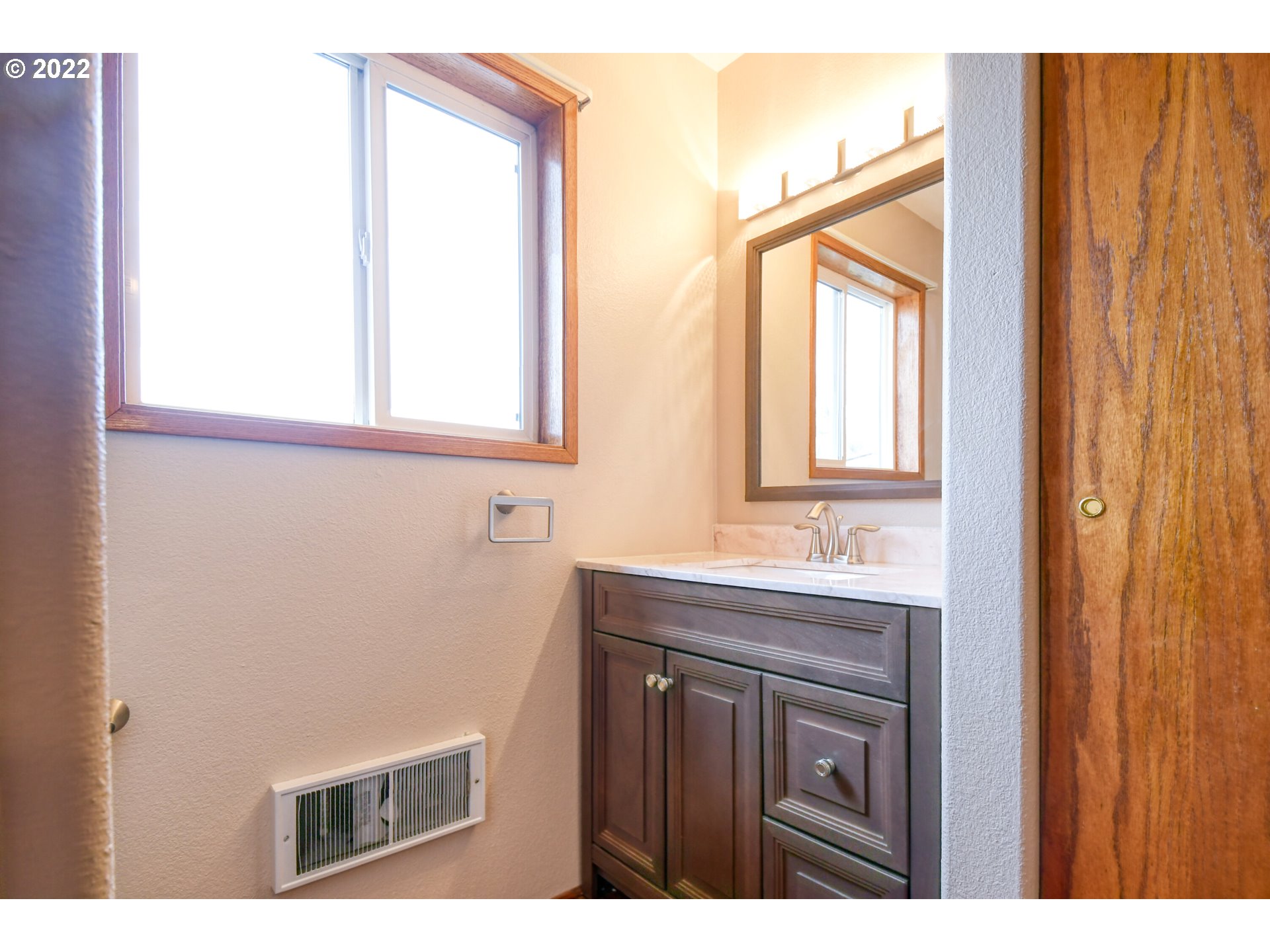 2011 Southwest Quinney Avenue Pendleton, OR 97801 - Photo 17 of 26 a bathroom with a sink a mirror and a vanity