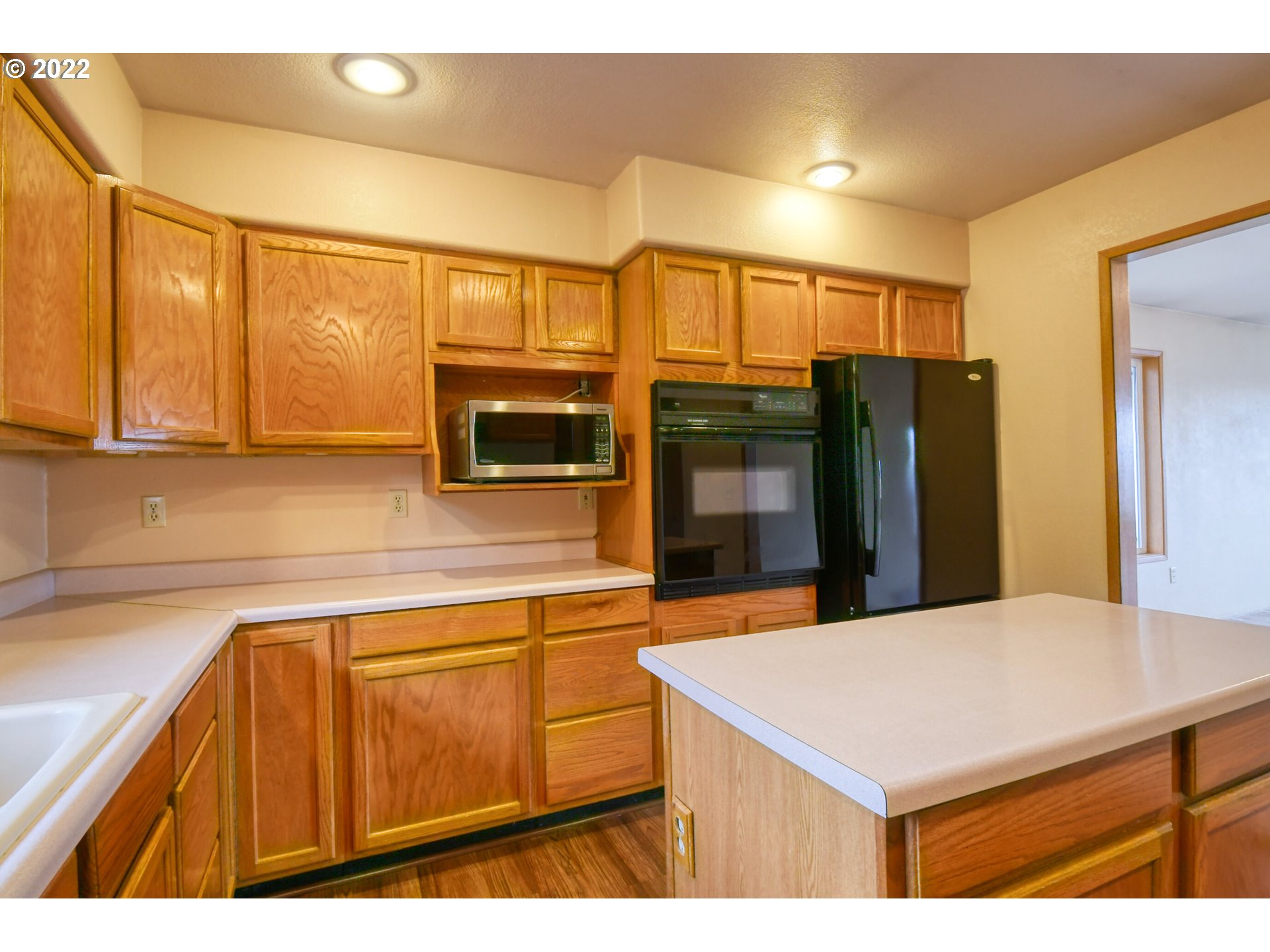 2011 Southwest Quinney Avenue Pendleton, OR 97801 - Photo 6 of 26 a kitchen with stainless steel appliances wooden cabinets a refrigerator and a sink