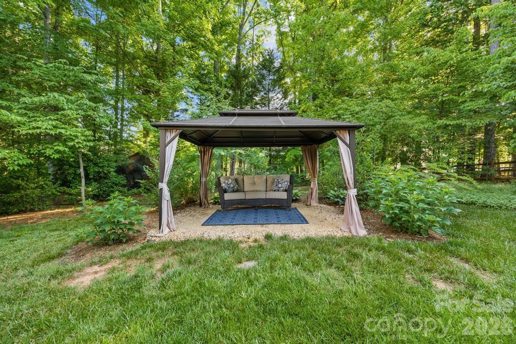 17028 Hampton Trace Road Huntersville, NC 28078 - Photo 33 of 41 a view of backyard with large trees and plants