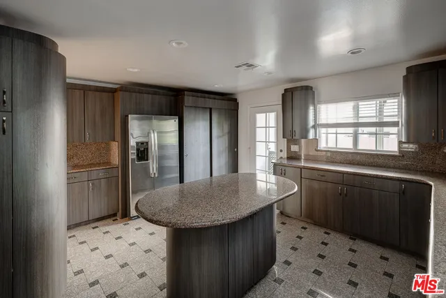 a kitchen with refrigerator and sink