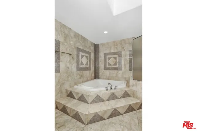 a bathroom with a tub and sink