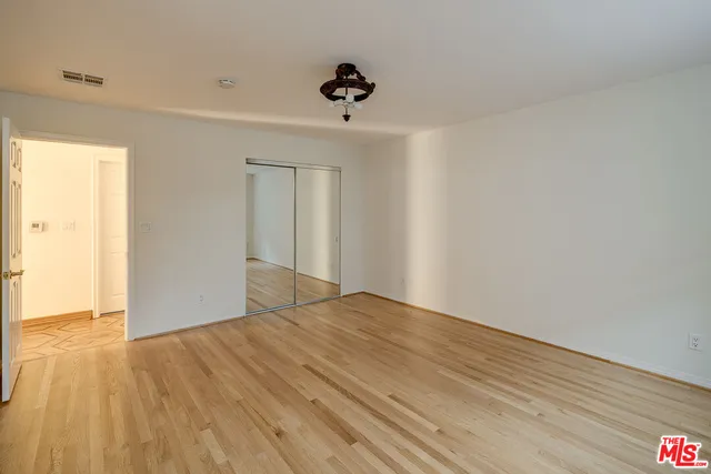 a view of an empty room and wooden floor