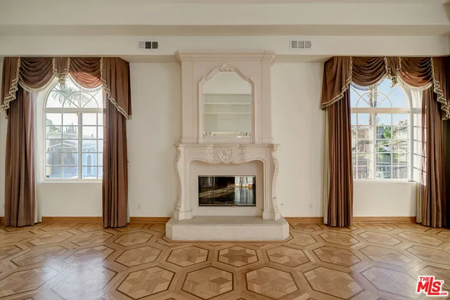 a view of a livingroom with a floor to ceiling window and a fireplace