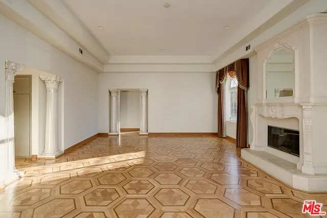 a view of a livingroom with an empty space and a fireplace