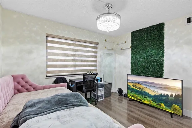 a bed room with a bed mirror and a window